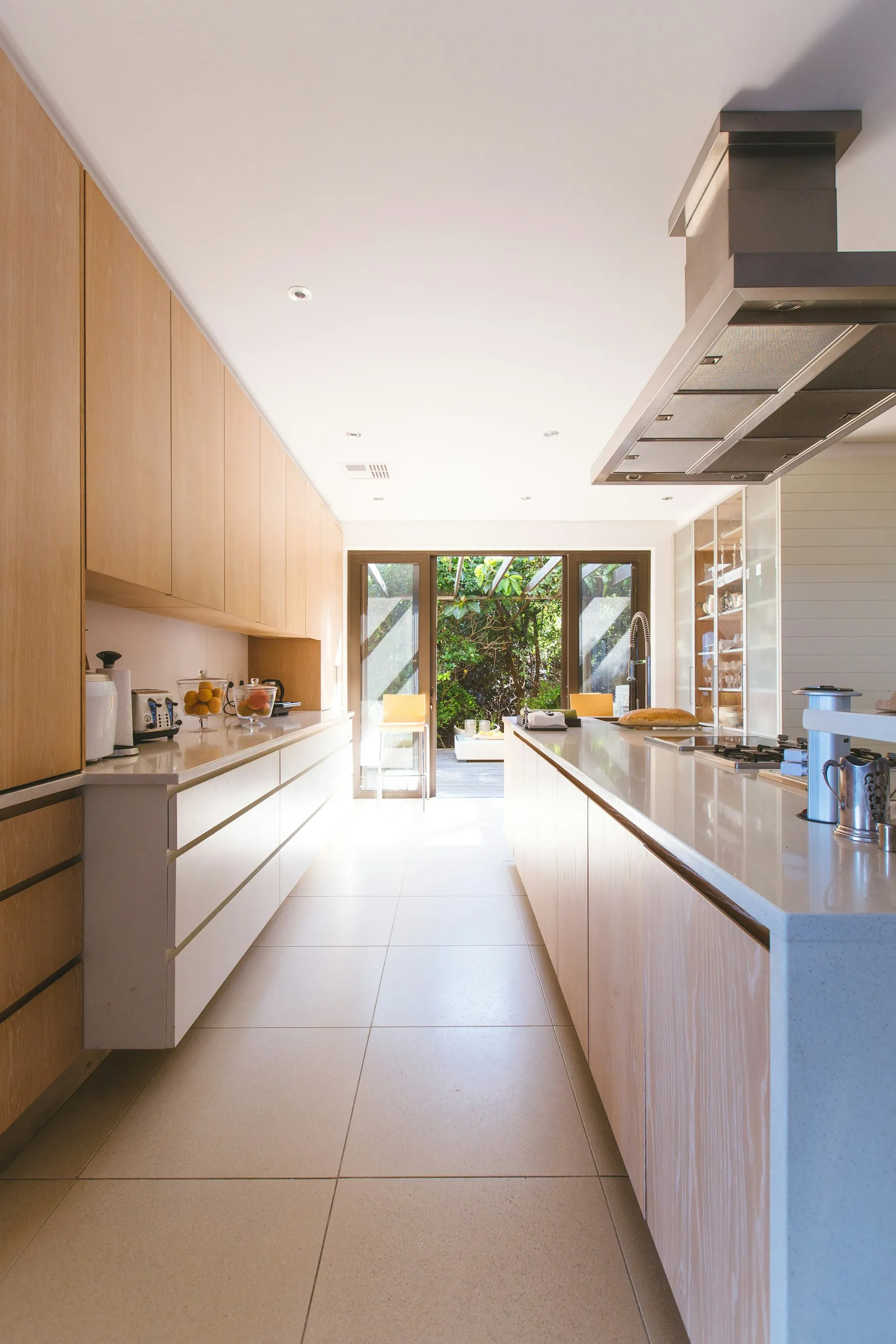 Bright kitchen-diner extension with a white island and glazed doors to the garden