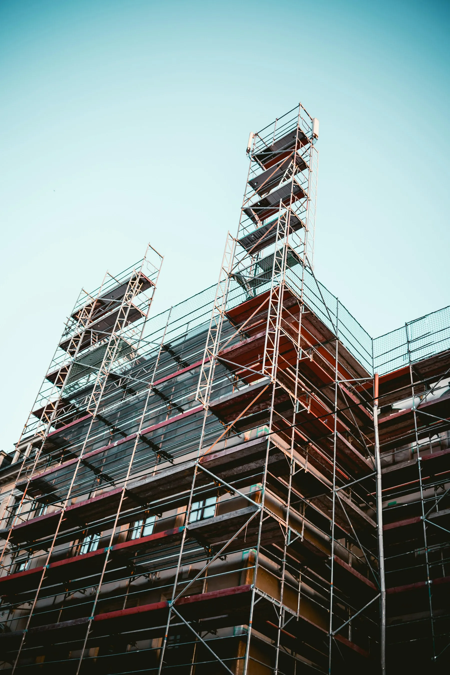 Looking up through scaffolding against the sky