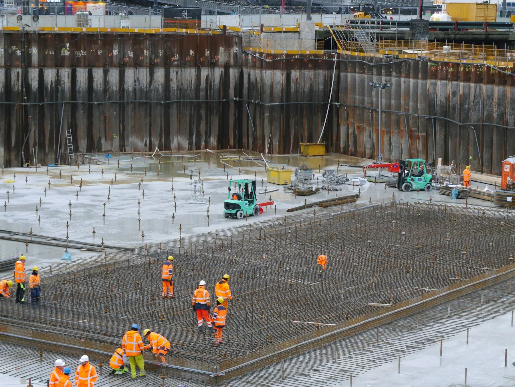 Site team in high-visibility clothing reviewing work on a construction site